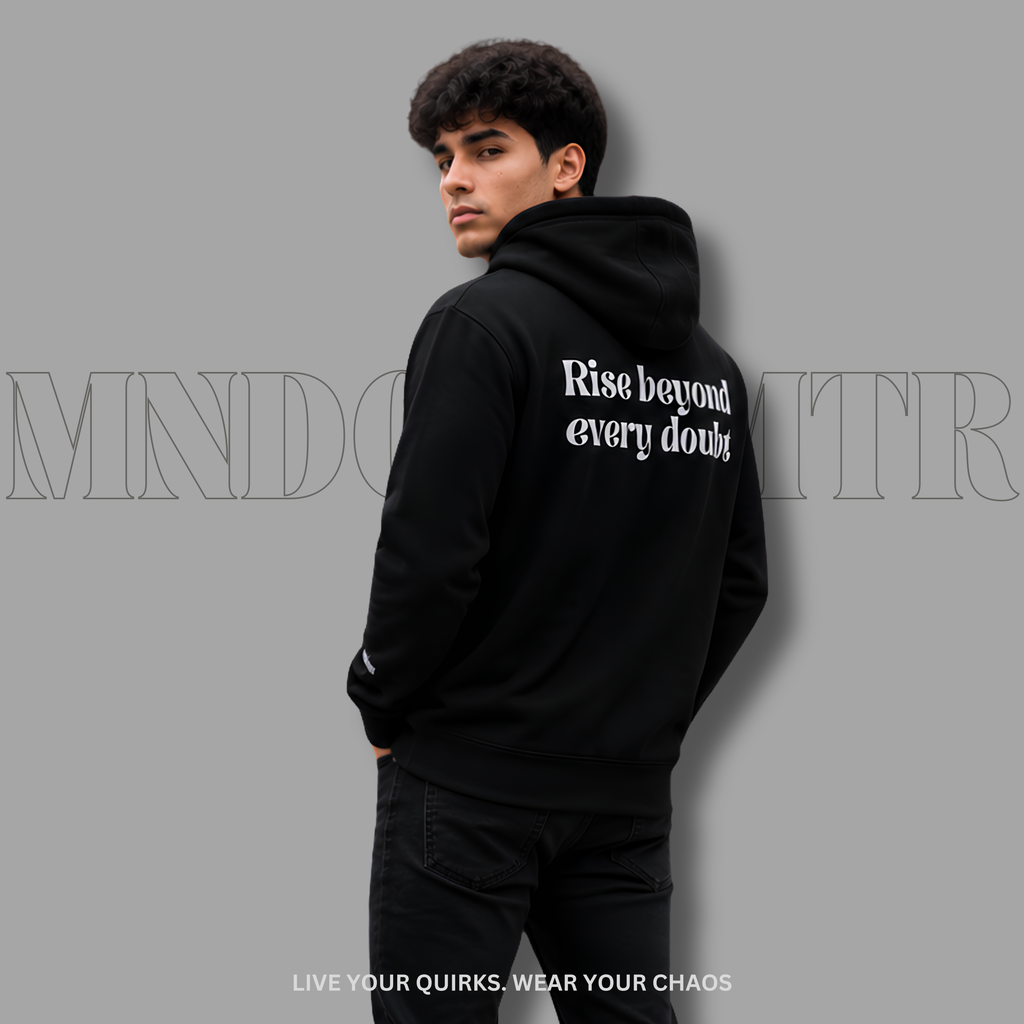 A man wearing a black fleece hoodie with the phrase 'Rise beyond every doubt' printed in grey, brasika font style text on the back, shown from a three-quarter back view against a solid gray background.