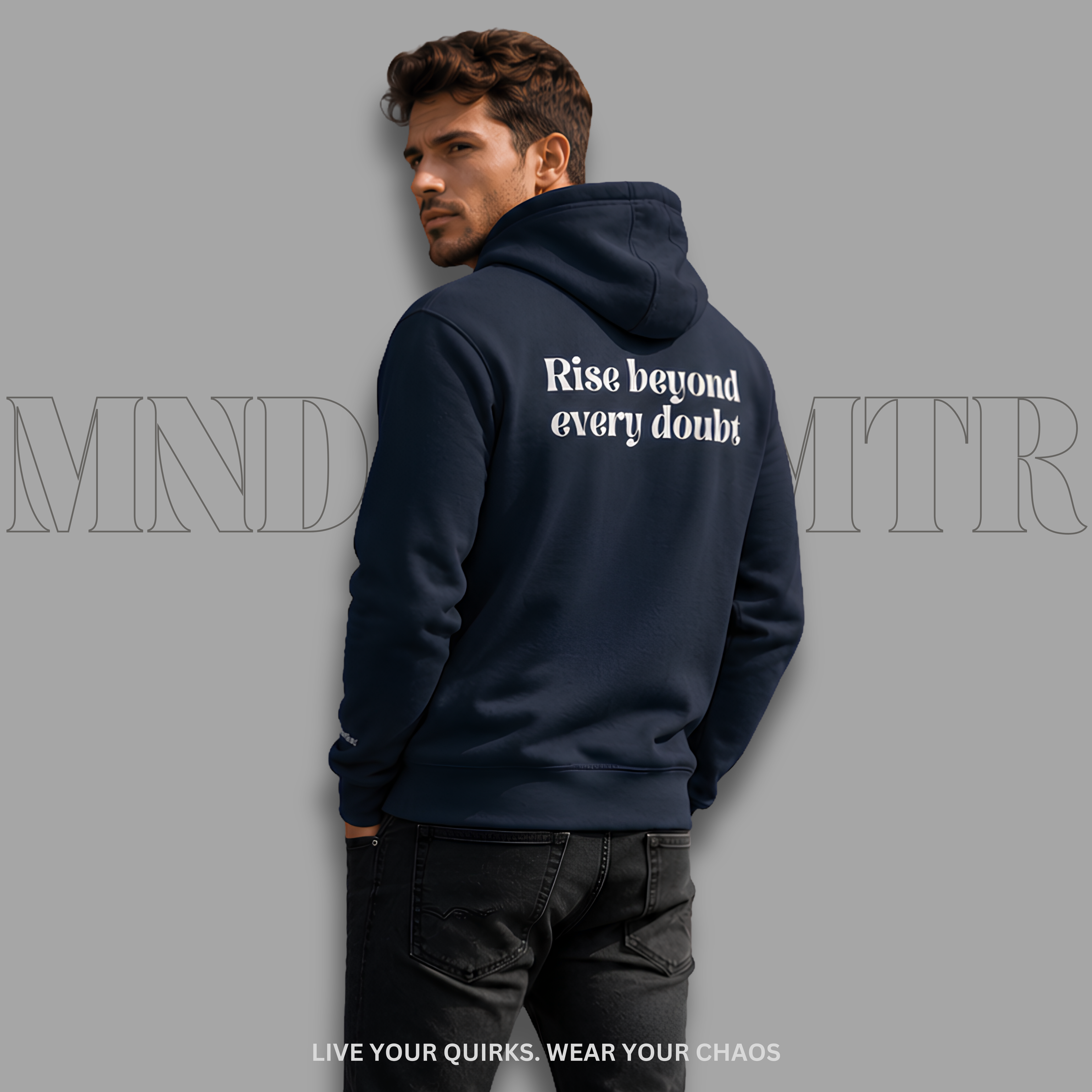 A man wearing a navy blue, fleece hoodie with the grey printed text 'Rise beyond every doubt' on the back, shown from behind against a gray background with faint brand text.