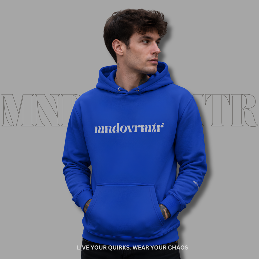 A man wearing a bright royal blue fleece hoodie with the word 'mndovrmtr' printed in grey across the chest, posed against a solid gray background with a faint brand watermark.