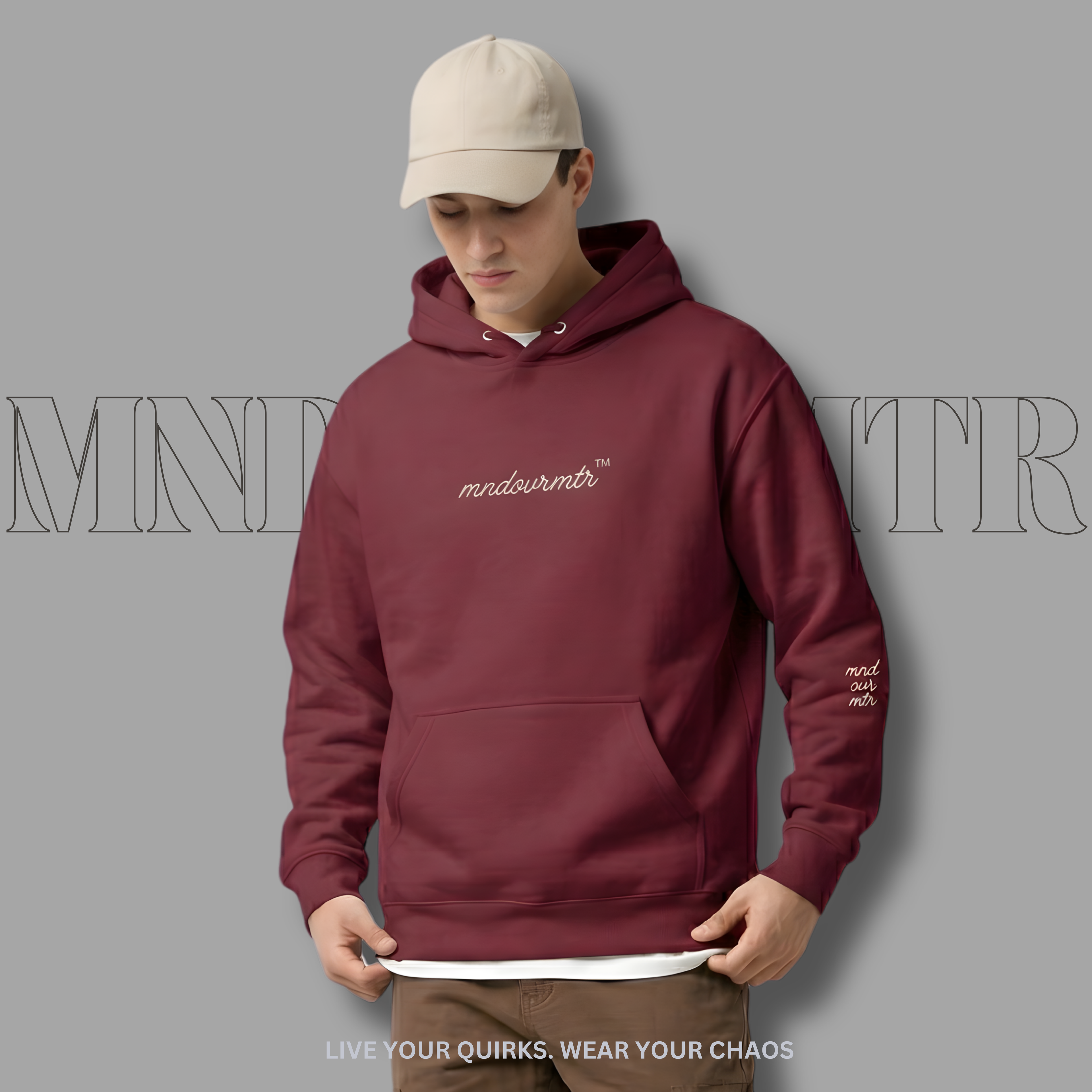 MNDOVRMTR oversized, maroon, fleece, hoodie worn by a fine male model with a brand logo on a gray background