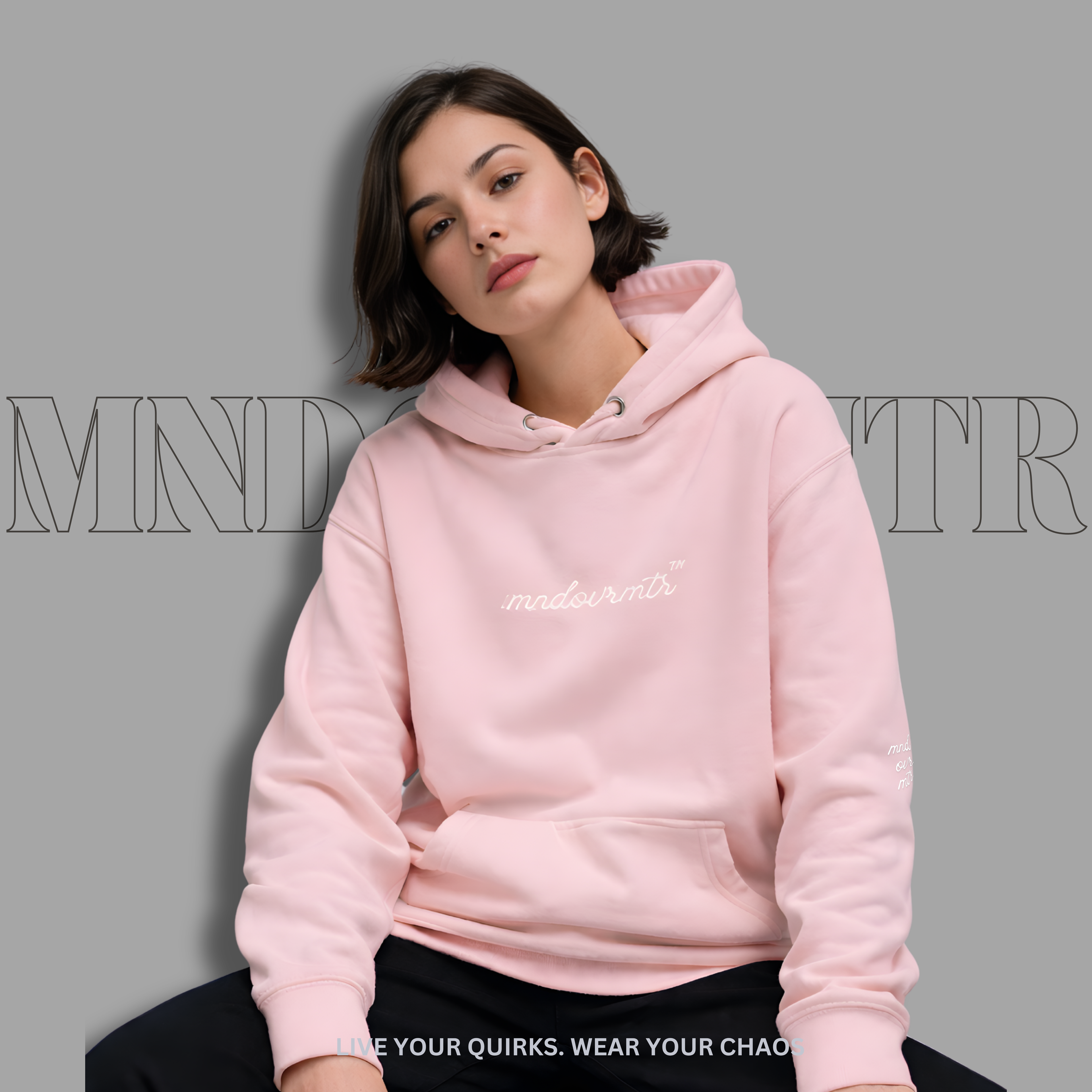 MNDOVRMTR oversized, pink, fleece, hoodie worn by a lovely female model with  "mndovrmtr" text on a gray background