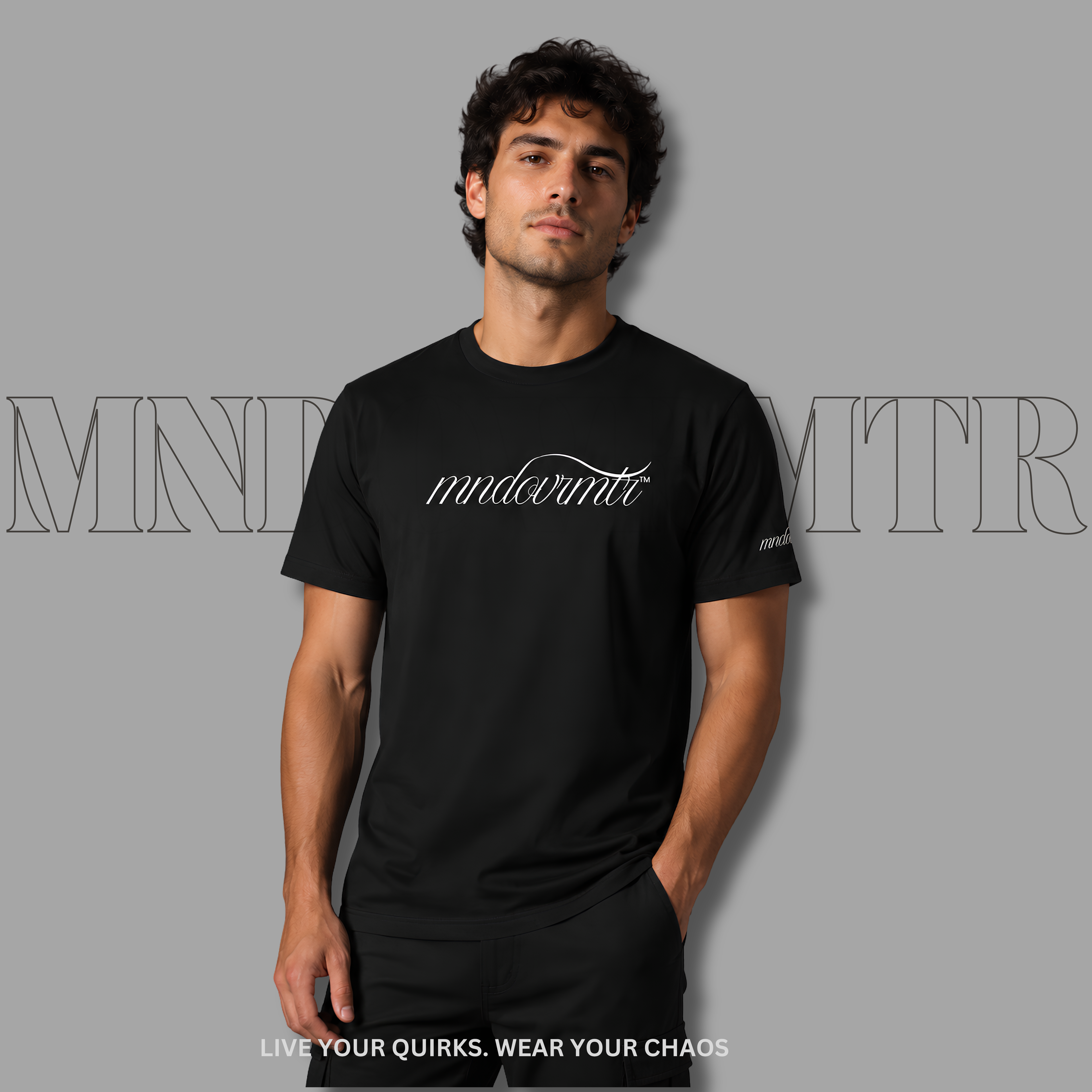 MNDOVRMTR Script Shirt – Minimalist  Black Mind Over Matter Streetwear Tee - worn by a stunning gentleman, casually standing against a gray background