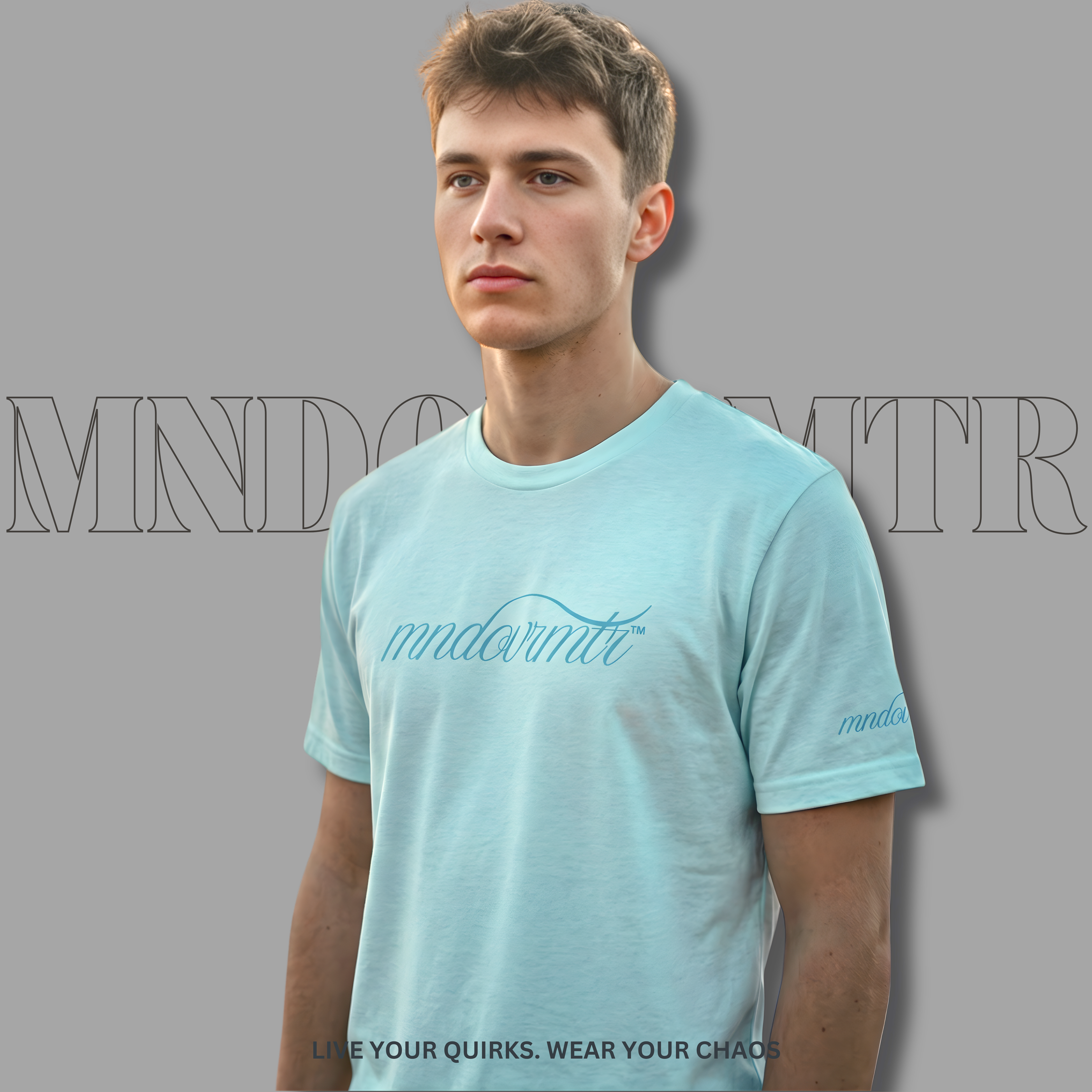 MNDOVRMTR Script Shirt – Minimalist Heather Ice Blue - Streetwear Tee - worn by a fine gentleman, casually standing against a gray background