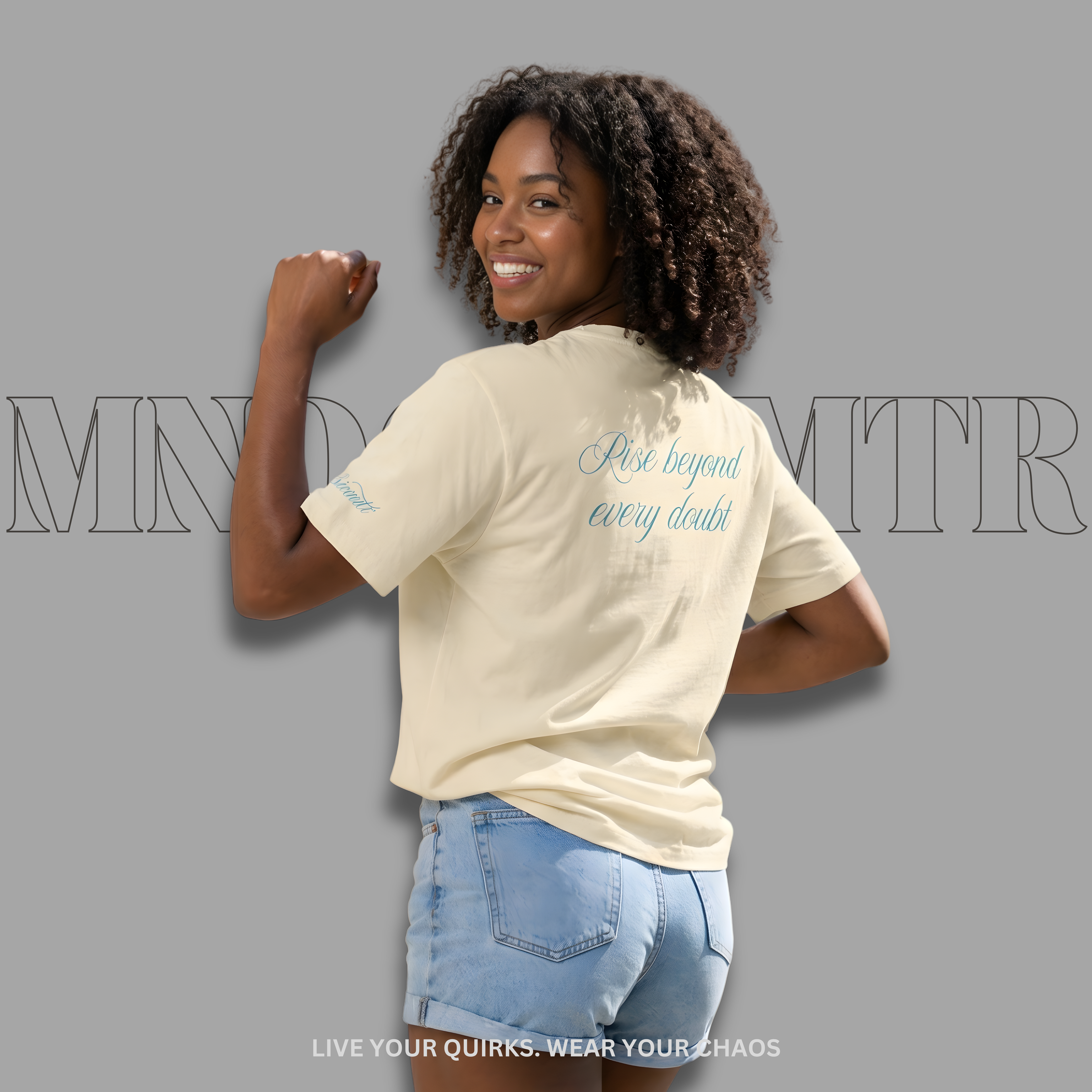 MNDOVRMTR Script Shirt – Minimalist Mind Over Matter Streetwear Tee - Natural colored worn by a stunning lady  in a denim shorts, against a gray background