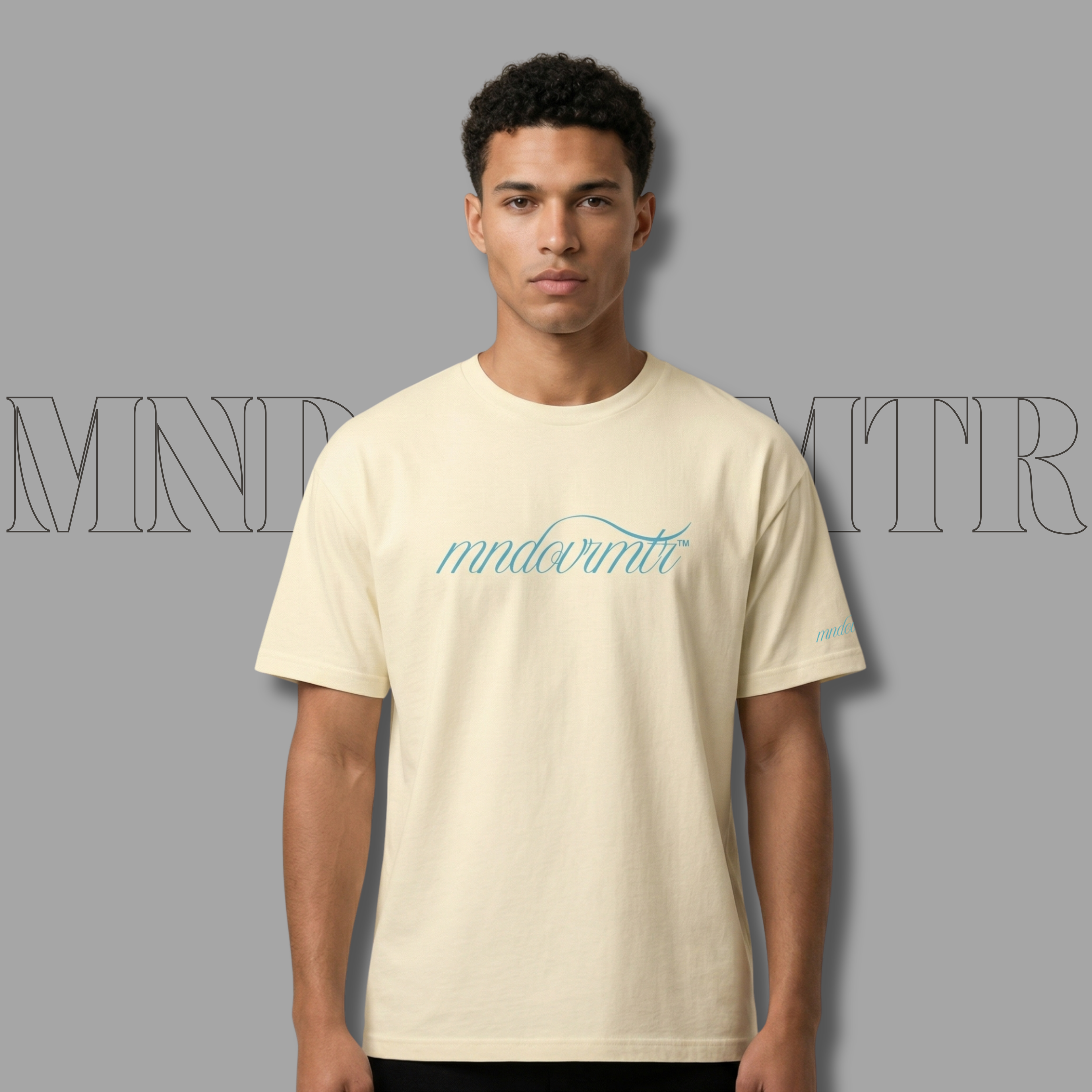 MNDOVRMTR Vintage White-Script Shirt – Minimalist Mind Over Matter Streetwear Tee - worn by a lovely male model standing against a grey colored background