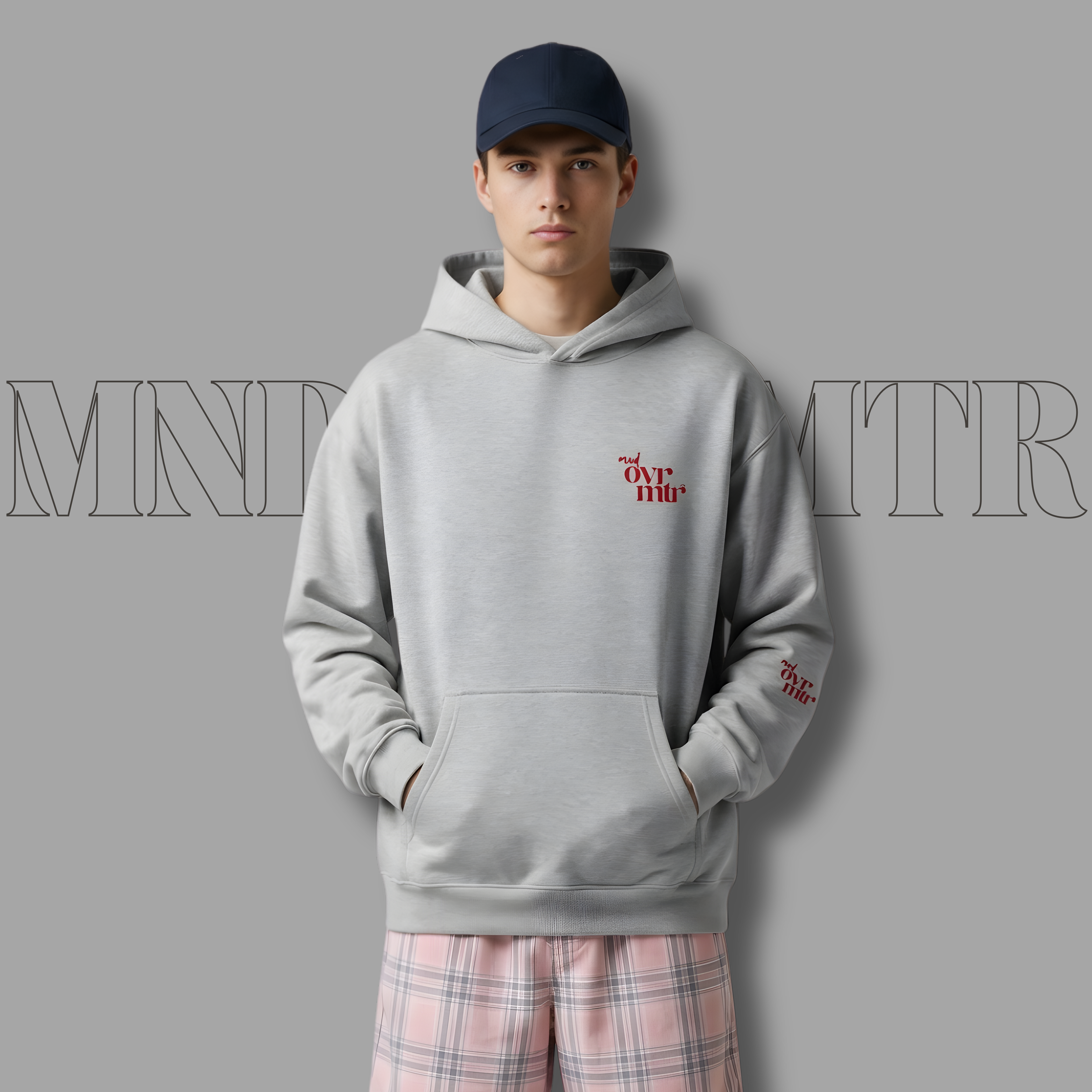 MNDOVRMTR™ men's box hoodie in grey - red stacked logo detail, front view
